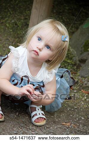 Stock Photo - A one-year-old caucasian girl outdoors.. Fotosearch