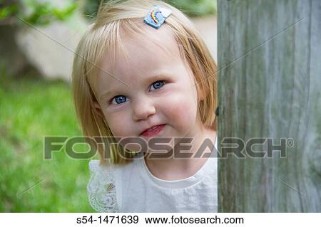 Stock Photo - A one-year-old caucasian girl outdoors.. Fotosearch