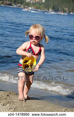 A one year old toddler plays at the lake View Large Photo Image Stock Photography - A one year old toddler plays at the lake. Fotosearch