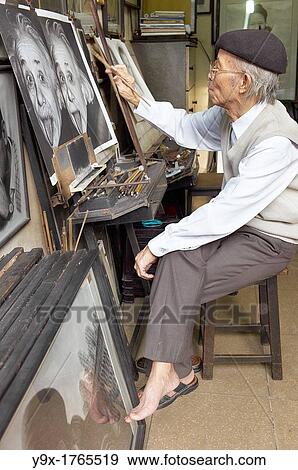 Stock Photo - A painter copying a picture of Albert Einstein. Fotosearch