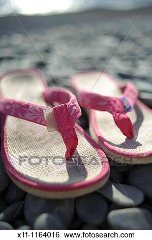 A pair of pink flip flops shoes on a pebble beach, summer UK View Large Photo Image Stock Photograph - A pair of pink flip flops shoes on a pebble beach, summer UK. Fotosearch