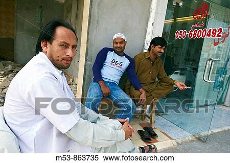 a pakistani barber wait for customer outside his shop in ras al-khaimah old town ras al-khaimah united arab emirates middle east View Large Photo Image Stock Photography - a pakistani barber wait for customer outside his shop in ras al-khaimah old town ras al-khaimah united arab emirates middle east. Fotosearch