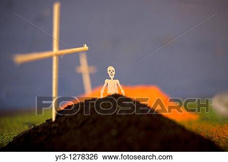 A paper skeleton decorates a tomb made of painted sand and wooden crosses as part of an altar ahead of Day of the Dead celebrations in Mexico City. View Large Photo Image Stock Photograph - A paper skeleton decorates a tomb made of painted sand and wooden crosses as part of an altar ahead of Day of the Dead celebrations in Mexico City.. Fotosearch