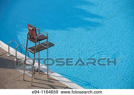 A partial view of a motel swimming pool showing water and an empty life guard stand. View Large Photo Image Stock Photo - A partial view of a motel swimming pool showing water and an empty life guard stand.. Fotosearch