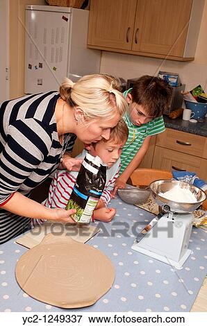A photo of 2 boys 7 & 10 and their mum weighing out cooking ingredients in the Uk View Large Photo Image Stock Photo - A photo of 2 boys 7 & 10 and their mum weighing out cooking ingredients in the Uk. Fotosearch