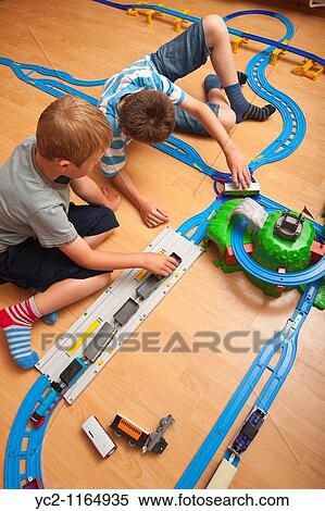 A photo of two boys 6 & 10 playing with a TOMY Thomas the tank engine train set in the Uk View Large Photo Image Stock Photography - A photo of two boys 6 & 10 playing with a TOMY Thomas the tank engine train set in the Uk. Fotosearch