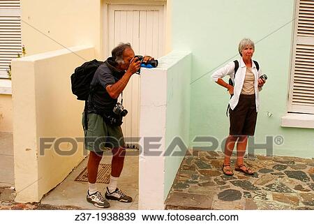 A photographer at work in a colorful street in Cape Town, South Africa View Large Photo Image Stock Photo - A photographer at work in a colorful street in Cape Town, South Africa. Fotosearch