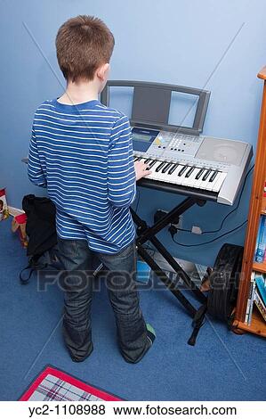 A picture of a 10 year old boy playing his keyboard in the uk View Large Photo Image Stock Photo - A picture of a 10 year old boy playing his keyboard in the uk. Fotosearch