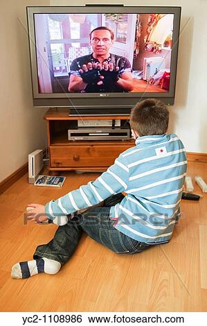 A picture of a 10 year old boy watching kids tv in the uk View Large Photo Image Stock Photograph - A picture of a 10 year old boy watching kids tv in the uk. Fotosearch