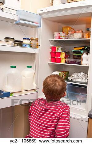 A picture of a 6 year old boy raiding the fridge in the uk View Large Photo Image Stock Photo - A picture of a 6 year old boy raiding the fridge in the uk. Fotosearch
