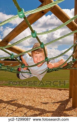 A picture of a seven year old boy on a climbing frame in the Uk View Large Photo Image Stock Photo - A picture of a seven year old boy on a climbing frame in the Uk. Fotosearch