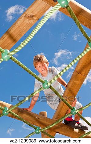 A picture of a seven year old boy on a climbing frame in the Uk View Large Photo Image Stock Photo - A picture of a seven year old boy on a climbing frame in the Uk. Fotosearch