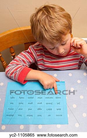Stock Photography - A picture of a six year old boy doing his literacy homework in the Uk. Fotosearch