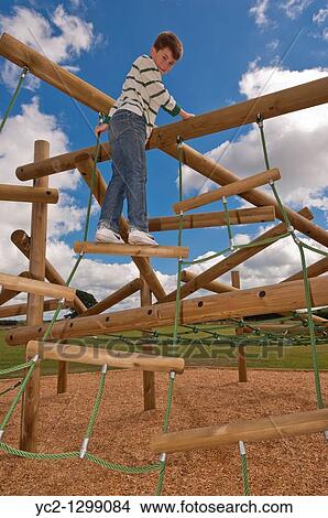 A picture of an eleven year old boy on a climbing frame in the Uk View Large Photo Image Picture - A picture of an eleven year old boy on a climbing frame in the Uk. Fotosearch