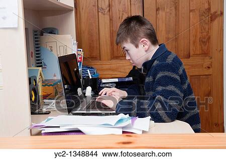 A picture of an eleven year old boy doing homework on his laptop computer in his bedroom View Large Photo Image Picture - A picture of an eleven year old boy doing homework on his laptop computer in his bedroom. Fotosearch
