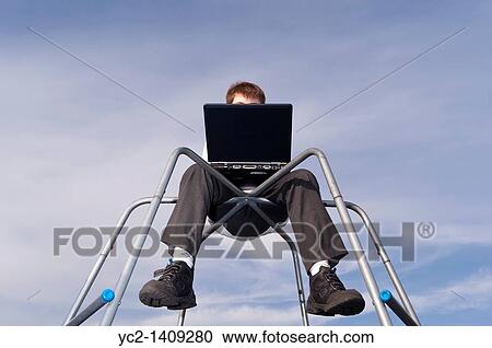 A picture of an eleven year old boy using his laptop computer outdoors on a climbing frame in the Uk View Large Photo Image Stock Image - A picture of an eleven year old boy using his laptop computer outdoors on a climbing frame in the Uk. Fotosearch
