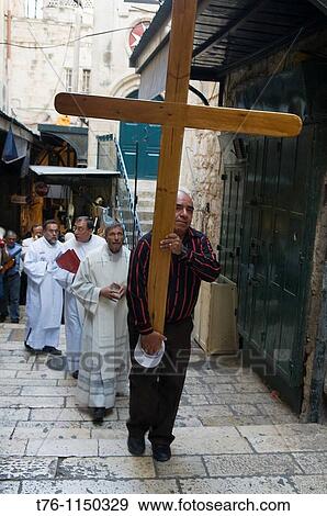 a pilgrim carries the cross following Jesus? steps on the Via Dolorosa in Jerusalem View Large Photo Image Stock Photo - a pilgrim carries the cross following Jesus? steps on the Via Dolorosa in Jerusalem. Fotosearch