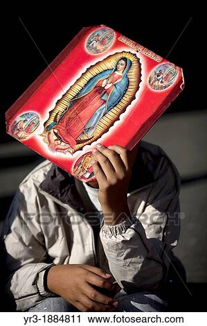 A pilgrim carrying an image of the Our Lady of Guadalupe covers his face from the sun outside of the Our Lady of Guadalupe Basilica in Mexico City, December 9, 2012 View Large Photo Image Stock Image - A pilgrim carrying an image of the Our Lady of Guadalupe covers his face from the sun outside of the Our Lady of Guadalupe Basilica in Mexico City, December 9, 2012. Fotosearch