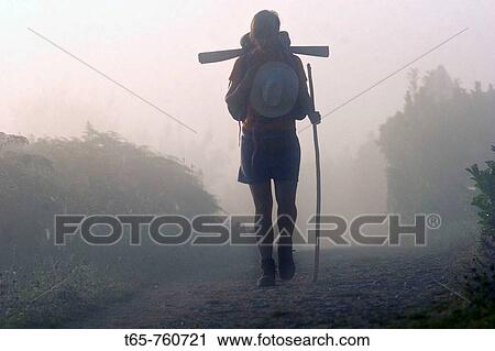 Stock Image - A pilgrim on the Camino de Santiago Camino Frances route by passing Portomar? n. Fotosearch