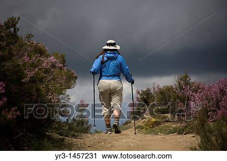 A pilgrim walks in a track located in the French Way that leads to Santiago de Compostela, in El Bierzo region, Leon province, Spain. View Large Photo Image Stock Image - A pilgrim walks in a track located in the French Way that leads to Santiago de Compostela, in El Bierzo region, Leon province, Spain.. Fotosearch