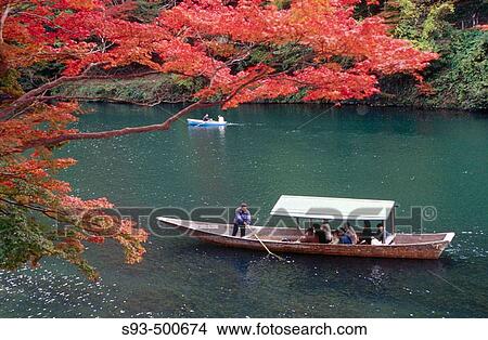 A pleasure boat being poled around Arashiyama's fall colors. Arashiyama. Kyoto. Japan. View Large Photo Image Picture - A pleasure boat being poled around Arashiyama's fall colors. Arashiyama. Kyoto. Japan.. Fotosearch