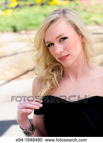A portrait of 23 year old blond woman in casual clothing in a garden setting. View Large Photo Image Stock Image - A portrait of 23 year old blond woman in casual clothing in a garden setting.. Fotosearch