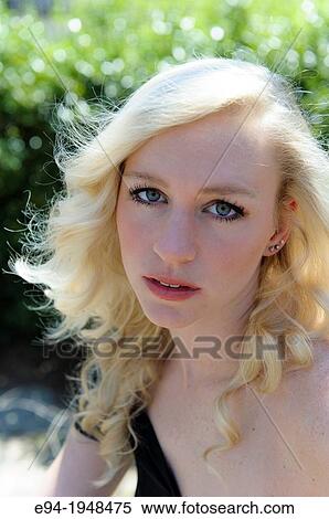A portrait of 23 year old blond woman in casual clothing in a garden setting. View Large Photo Image Stock Photography - A portrait of 23 year old blond woman in casual clothing in a garden setting.. Fotosearch