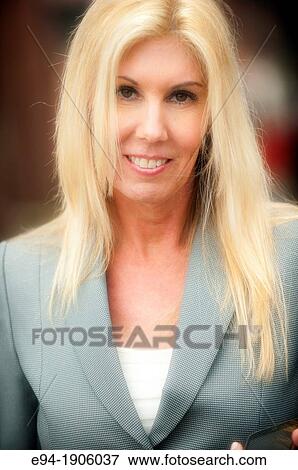 A portrait of a 48 year old blond woman in a business suit looking at the camera View Large Photo Image Stock Photo - A portrait of a 48 year old blond woman in a business suit looking at the camera. Fotosearch