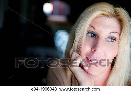A portrait of a 48 year old blond woman looking away from the camera, hand on chin View Large Photo Image Stock Photo - A portrait of a 48 year old blond woman looking away from the camera, hand on chin. Fotosearch