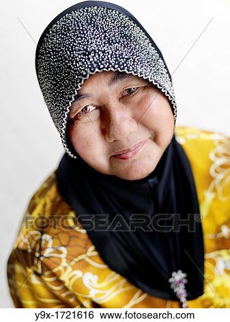 A portrait of a elderly woman wearing an embellished headscarf taken in Johor, Malaysia. View Large Photo Image Stock Photograph - A portrait of a elderly woman wearing an embellished headscarf taken in Johor, Malaysia.. Fotosearch