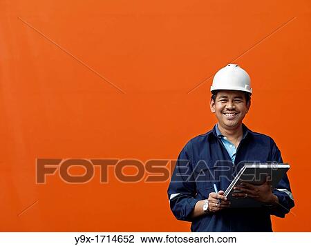 A portrait of a inspector at a commerical container and Palm Oil port in Johor, Malaysia View Large Photo Image Stock Image - A portrait of a inspector at a commerical container and Palm Oil port in Johor, Malaysia. Fotosearch