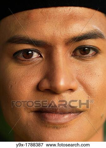 A portrait of a traditionally dressed Malaysian man View Large Photo Image Stock Photo - A portrait of a traditionally dressed Malaysian man. Fotosearch
