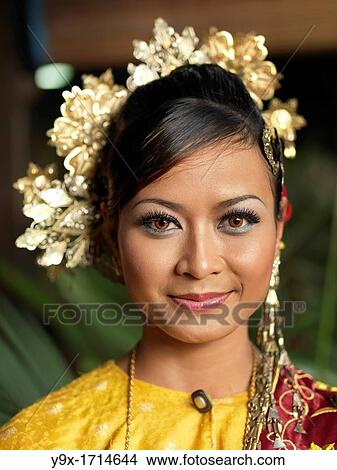 A portrait of Traditional Malaysian dancer wearing a headpiece and stage Make-Up. View Large Photo Image Picture - A portrait of Traditional Malaysian dancer wearing a headpiece and stage Make-Up.. Fotosearch