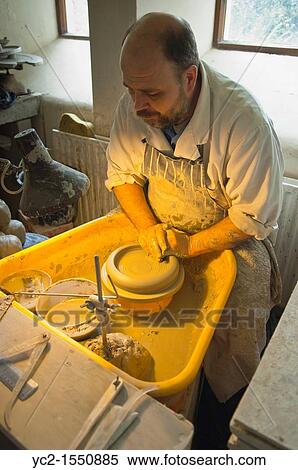 Stock Photography - A potter at work in the Wensleydale Pottery in Hawes in Wensleydale in North Yorkshire, England, Britain, Uk. Fotosearch