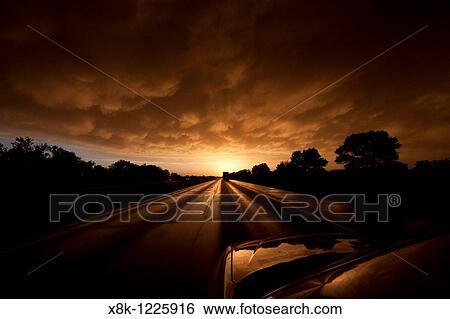 A POV shot from a moving car on Interstate 80 in Nebraska, May 24, 2010 The sun is setting against the clouds pouring out of a squall line thunderstorm View Large Photo Image Stock Photograph - A POV shot from a moving car on Interstate 80 in Nebraska, May 24, 2010 The sun is setting against the clouds pouring out of a squall line thunderstorm. Fotosearch