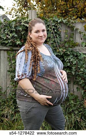 A pregnant young caucasian woman, a few weeks before her due date View Large Photo Image Stock Image - A pregnant young caucasian woman, a few weeks before her due date. Fotosearch