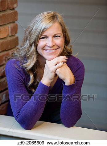 A pretty blonde smiles beautifully. View Large Photo Image Stock Photo - A pretty blonde smiles beautifully.. Fotosearch