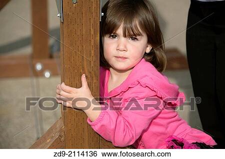 A pretty young girl is a bit camera shy. View Large Photo Image Stock Photograph - A pretty young girl is a bit camera shy.. Fotosearch