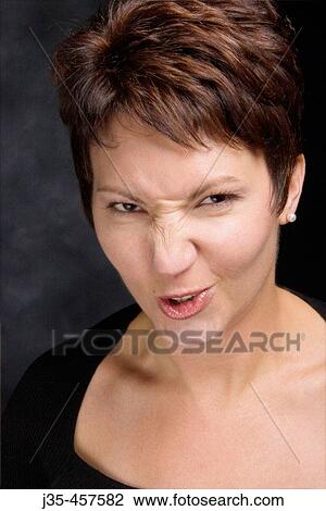 A pretty young woman, 20? s, 30? s, makes a funny face as if she is disgusted about something View Large Photo Image Stock Image - A pretty young woman, 20? s, 30? s, makes a funny face as if she is disgusted about something. Fotosearch