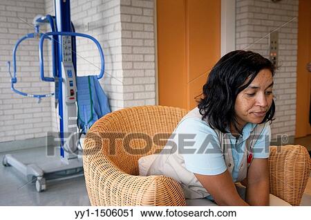 Stock Image - A professional nurse of a Rotterdam nursing home having a coffee break after hard work.. Fotosearch