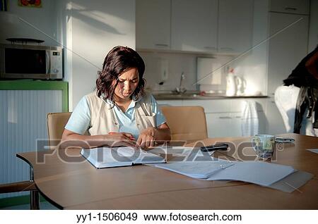A professional nurse of a Rotterdam nursing home reading documentation at the start of her shift. View Large Photo Image Stock Photo - A professional nurse of a Rotterdam nursing home reading documentation at the start of her shift.. Fotosearch