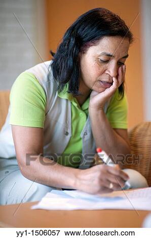 Stock Photo - A professional nurse of a Rotterdam nursing home documenting her work with elderly inhabitants during the day.. Fotosearch