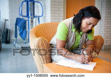 A professional nurse of a Rotterdam nursing home documenting her work with elderly inhabitants during the day. View Large Photo Image Stock Photography - A professional nurse of a Rotterdam nursing home documenting her work with elderly inhabitants during the day.. Fotosearch