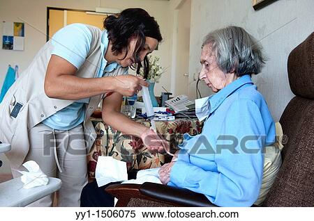 A professional nurse of a Rotterdam nursing home helping an elderly inhabitant with her stomach pump. View Large Photo Image Stock Photography - A professional nurse of a Rotterdam nursing home helping an elderly inhabitant with her stomach pump.. Fotosearch