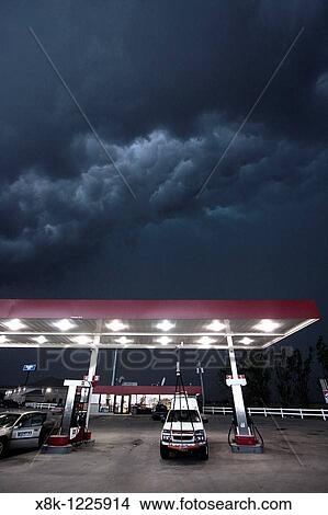A Project Vortex 2 storm chaser waits out a squall line beneath a gas station awning in Nebraska, May 24, 2010 View Large Photo Image Picture - A Project Vortex 2 storm chaser waits out a squall line beneath a gas station awning in Nebraska, May 24, 2010. Fotosearch