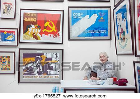 A propaganda poster shop in Vietnam with a man sitting behind a desk View Large Photo Image Stock Photo - A propaganda poster shop in Vietnam with a man sitting behind a desk. Fotosearch