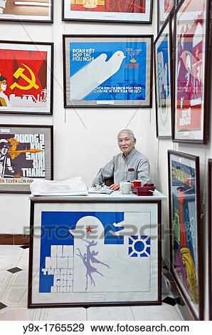 A propaganda poster shop in Vietnam with a man sitting behind a desk View Large Photo Image Stock Photo - A propaganda poster shop in Vietnam with a man sitting behind a desk. Fotosearch