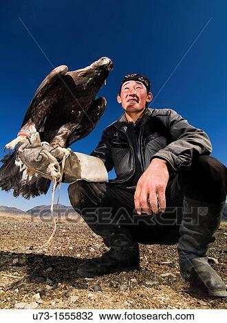 A proud Kazakh eagle hunter holding his Golden Eagle. View Large Photo Image Stock Image - A proud Kazakh eagle hunter holding his Golden Eagle.. Fotosearch