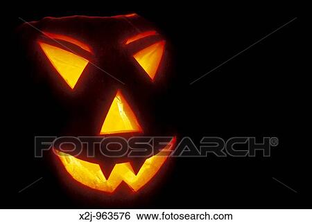 Stock Photograph - A pumpkin carved into a jack-? o-lantern for haloween. Fotosearch