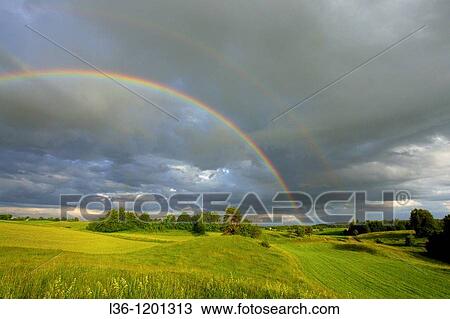 Stock Image - A rainbow after a strom. Podlasie region. Eastern Poland. Fotosearch